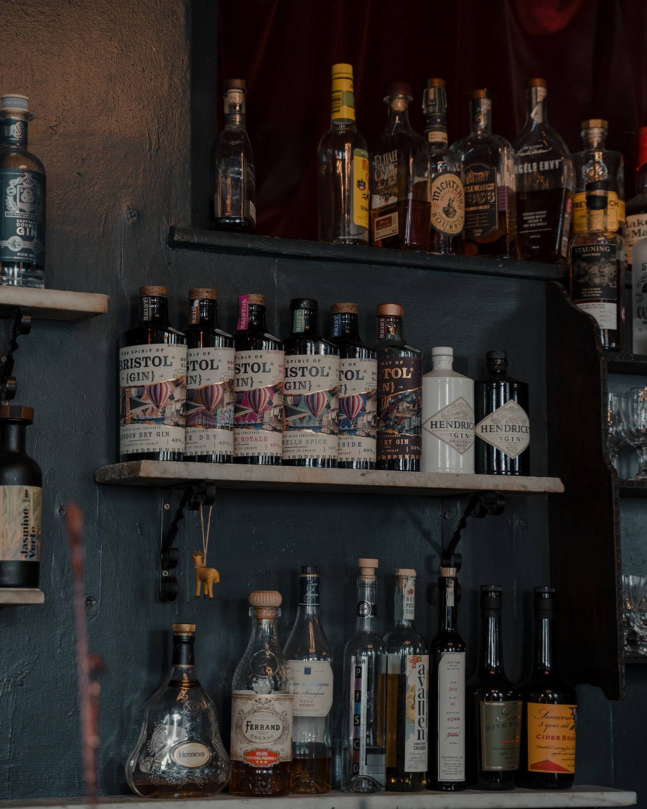 A shelf of Bristol gin bottles behind the bar at The Milk Thistle
